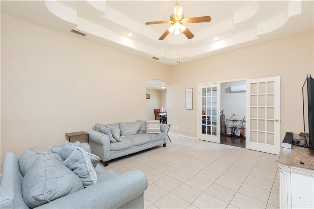 1801 Largo Street Weslaco, TX 78596 - Photo 2 of 20 a living room with furniture and a chandelier