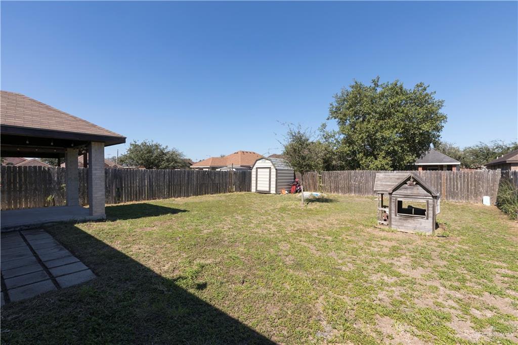 1801 Largo Street Weslaco, TX 78596 - Photo 8 of 20 a view of a backyard with a table and chairs