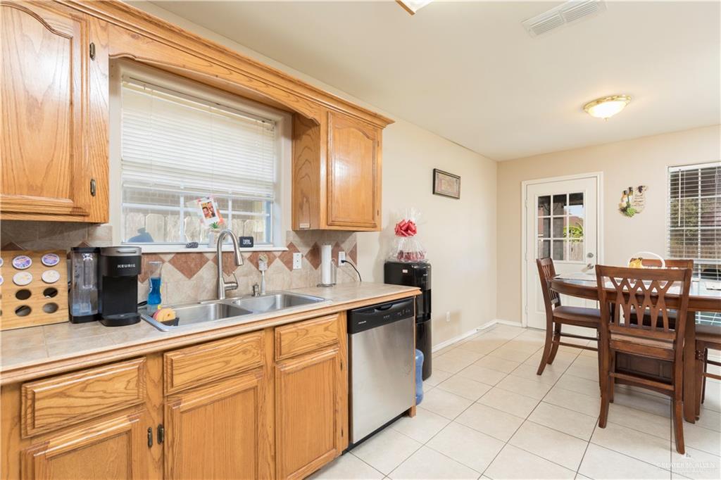 1801 Largo Street Weslaco, TX 78596 - Photo 10 of 20 a kitchen with cabinets and chairs