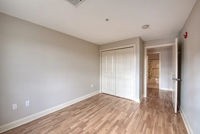 a view of an empty room and wooden floor