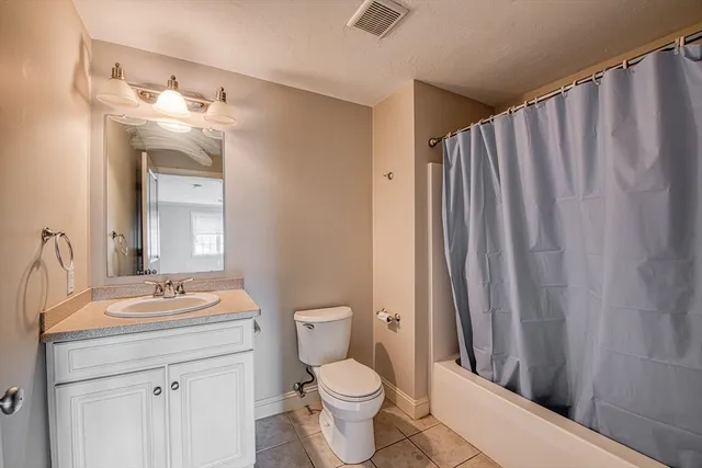 a bathroom with a toilet a sink and a mirror