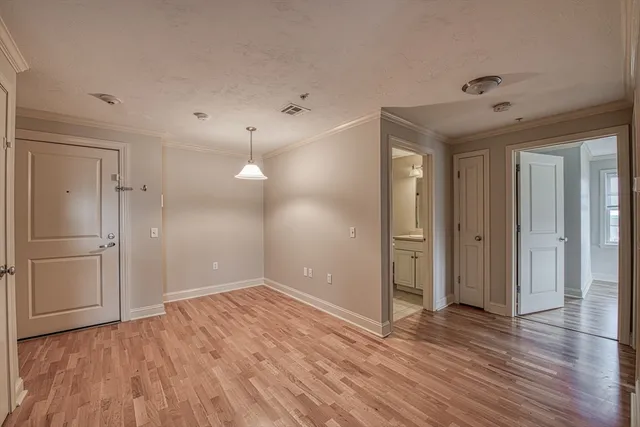 a view of a room with wooden floor and a ceiling fan