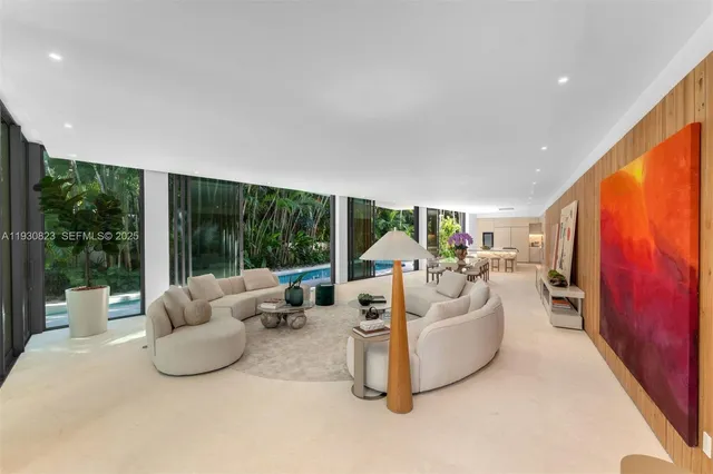 a dining room with furniture and a floor to ceiling window
