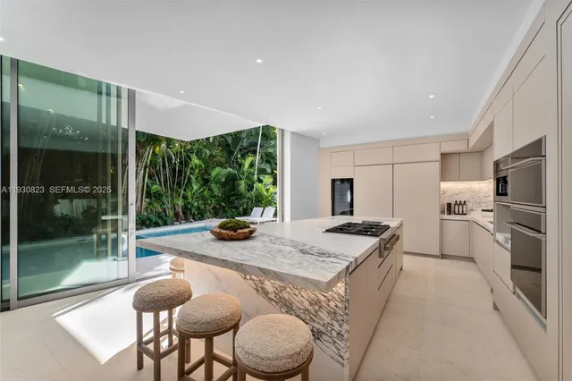 a view of a patio with table and chairs a barbeque with wooden floor and fence