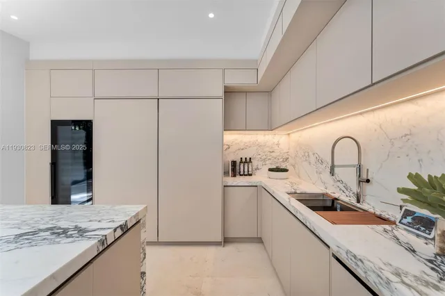 a living room with patio furniture and a potted plants