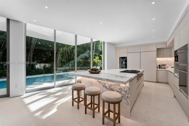 a view of a house with a swimming pool and sitting area