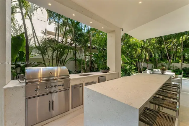 a view of a patio with table and chairs and a large tree