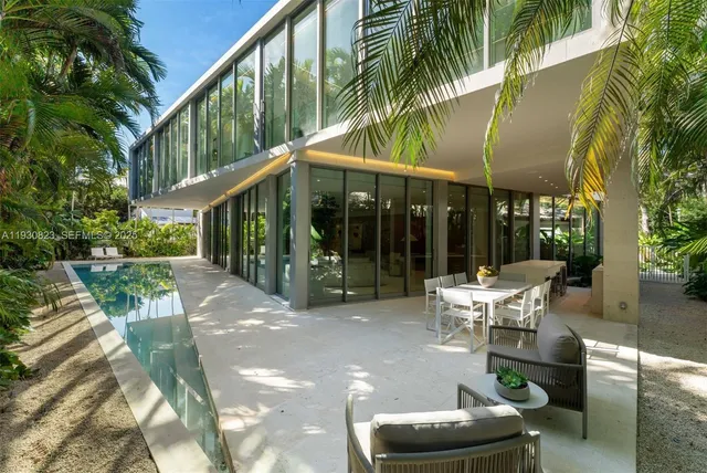 a bathroom with a granite countertop sink a mirror and a shower