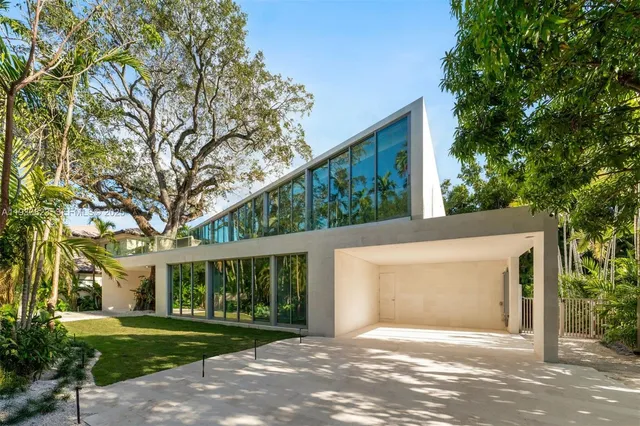 a view of a house with a tree in front of it