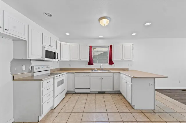 a kitchen that has a sink and a stove in it