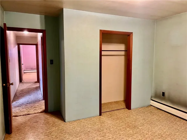 a view of a room with wooden floor and a window