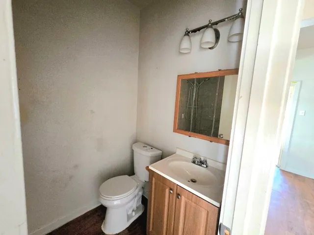 a bathroom with a toilet sink and vanity