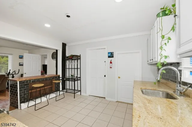 a kitchen with granite countertop a sink cabinets and window