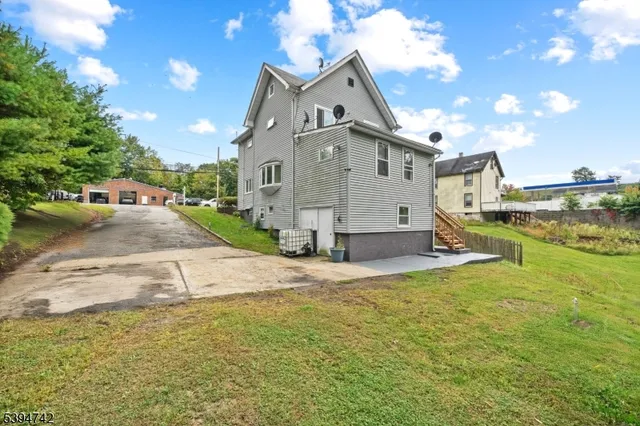 a view of a house with a yard and sitting area
