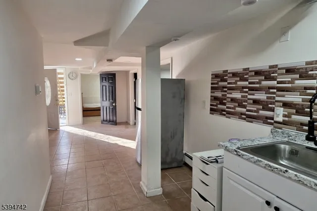 a kitchen with a refrigerator and a sink