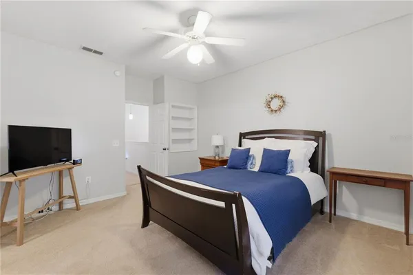 a bedroom with a bed and a chandelier