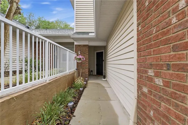 a view of a balcony with wooden floor and fence