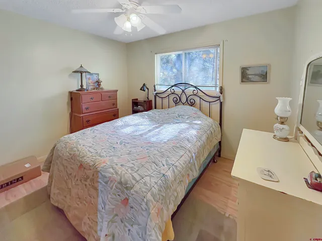a large bed sitting in a bedroom next to a chandelier