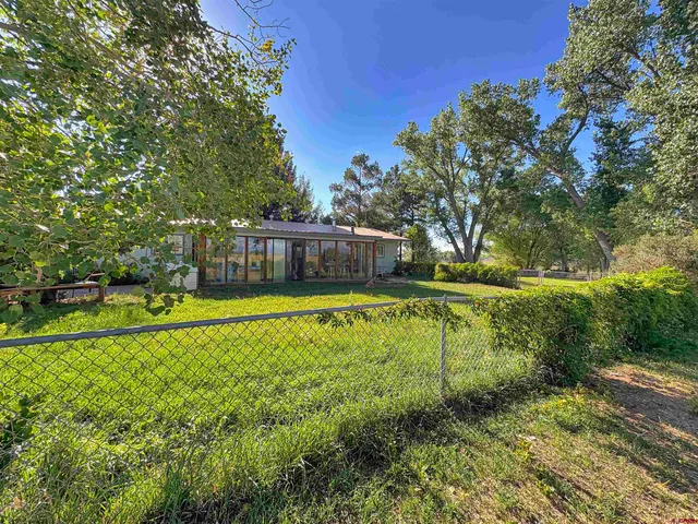 a swimming pool with outdoor seating and yard