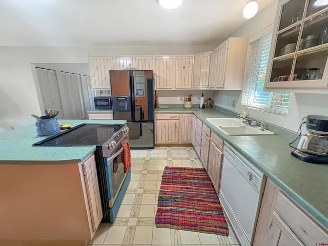 a kitchen with a sink a stove and refrigerator