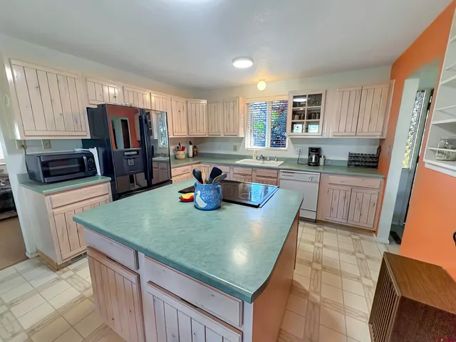 a kitchen with stainless steel appliances granite countertop a sink microwave and stove