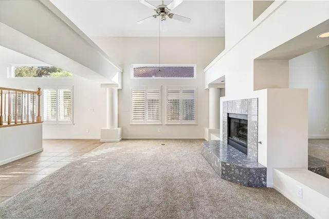 a view of livingroom with fireplace chandelier and windows