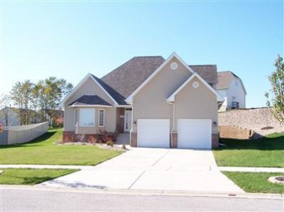 a front view of a house with a yard and potted plants