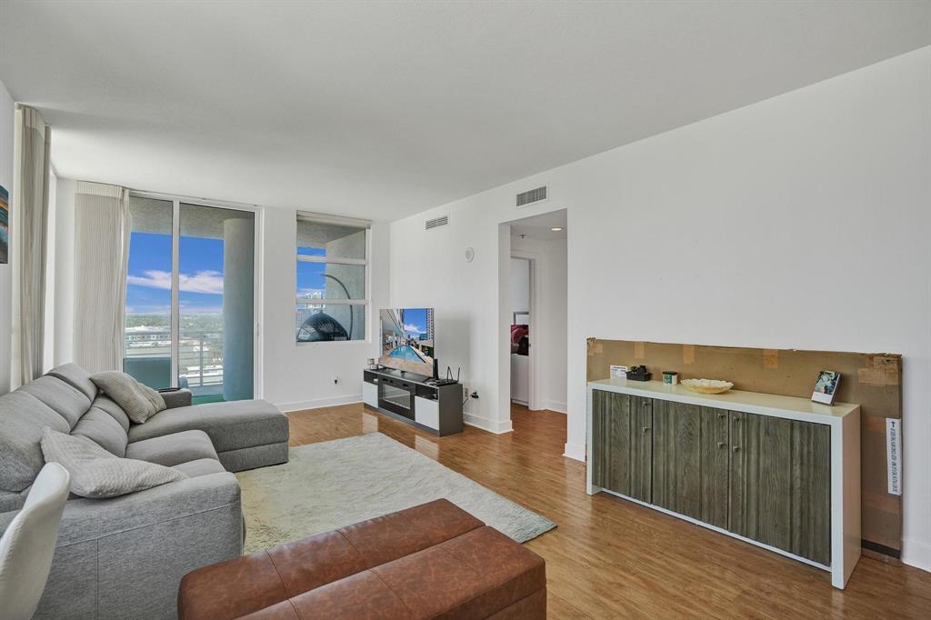 315 Northeast 3rd Avenue, Unit 1201 Fort Lauderdale, FL 33301 - Photo 11 of 49 a living room with furniture and a wooden floor