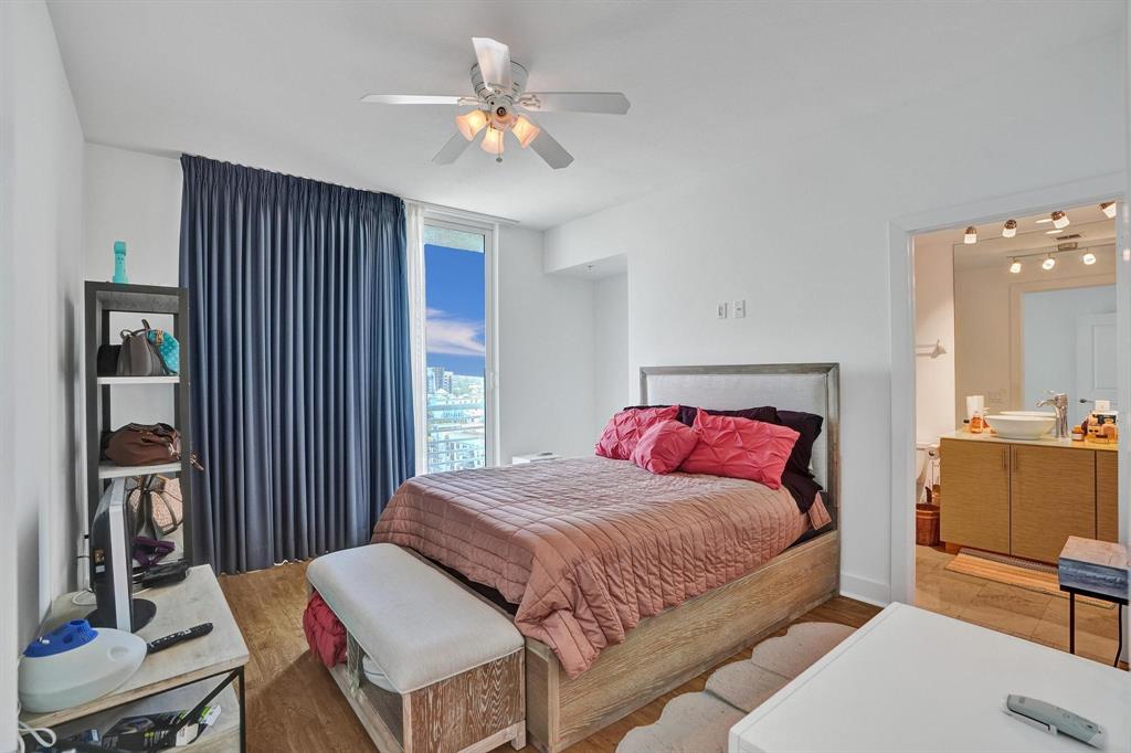 315 Northeast 3rd Avenue, Unit 1201 Fort Lauderdale, FL 33301 - Photo 12 of 49 a bedroom with a bed and a chandelier