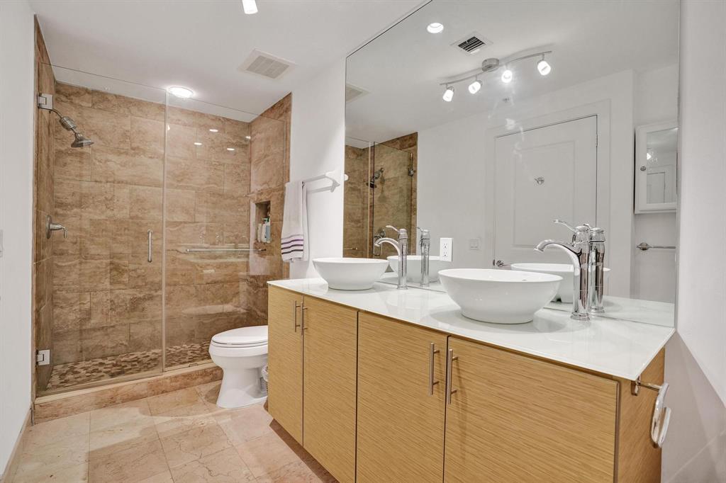 315 Northeast 3rd Avenue, Unit 1201 Fort Lauderdale, FL 33301 - Photo 15 of 49 a bathroom with a double vanity sink toilet and shower
