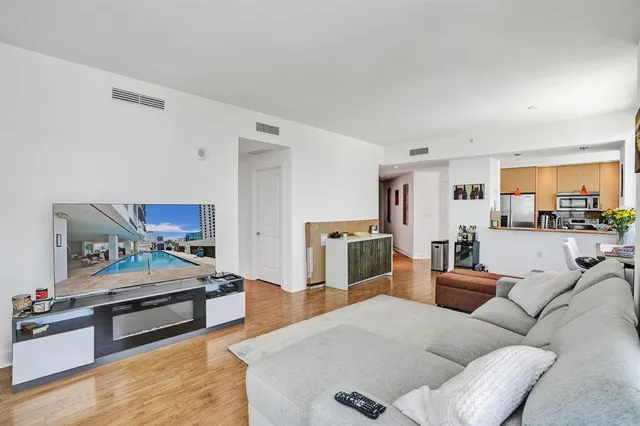a bedroom with furniture and a view of kitchen