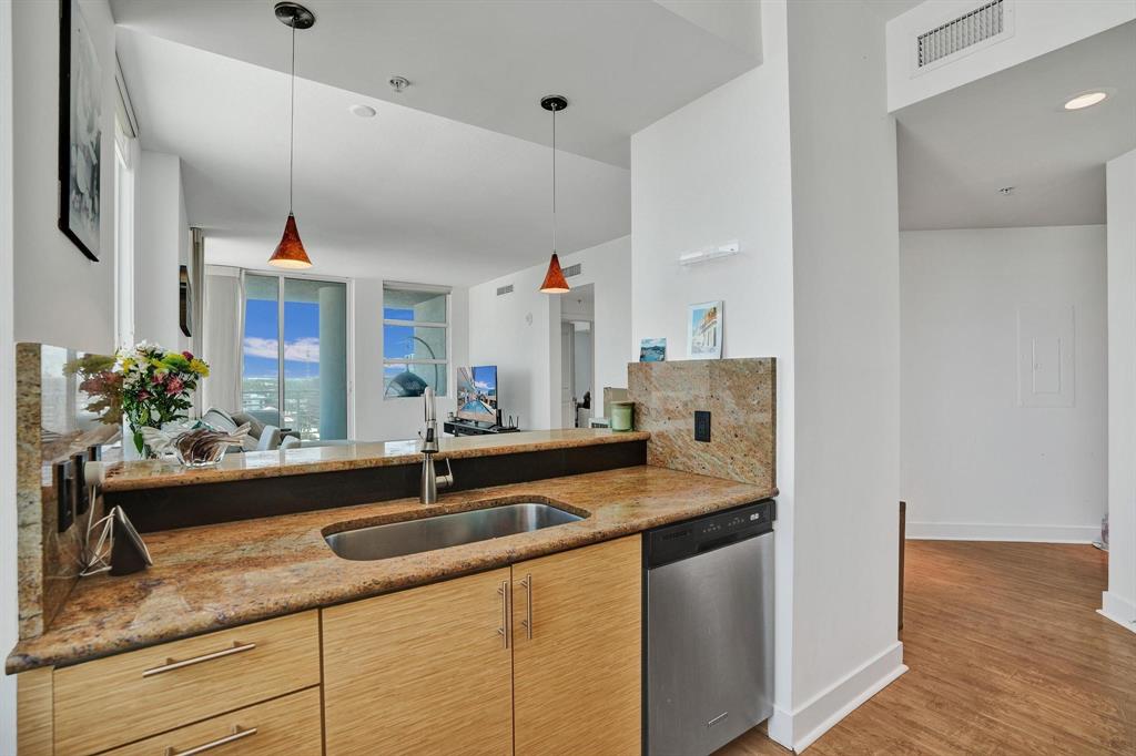 315 Northeast 3rd Avenue, Unit 1201 Fort Lauderdale, FL 33301 - Photo 9 of 49 a kitchen with a sink and a refrigerator