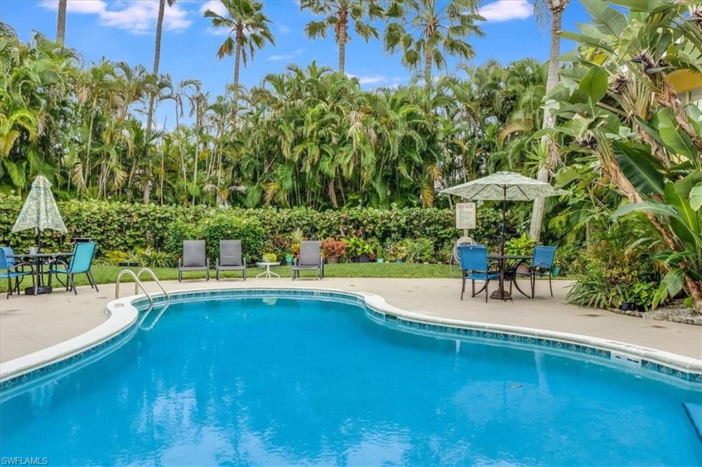 4290 Gulfstream Drive, Unit 4 Naples, FL 34112 - Photo 1 of 20 a view of a swimming pool with a patio