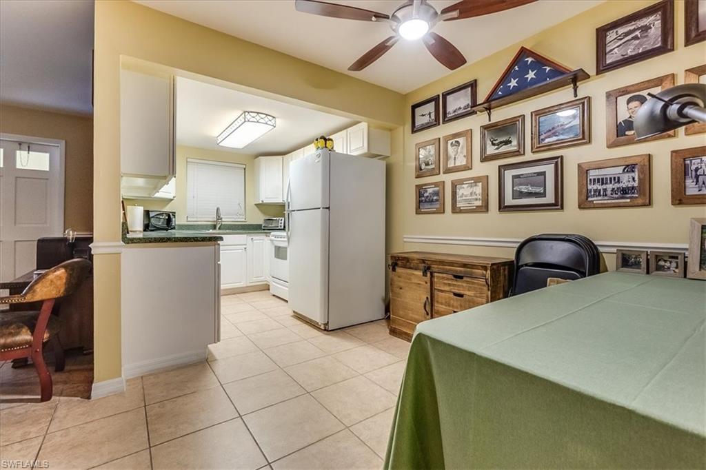 4290 Gulfstream Drive, Unit 4 Naples, FL 34112 - Photo 15 of 20 a kitchen with stainless steel appliances granite countertop a refrigerator and a stove top oven