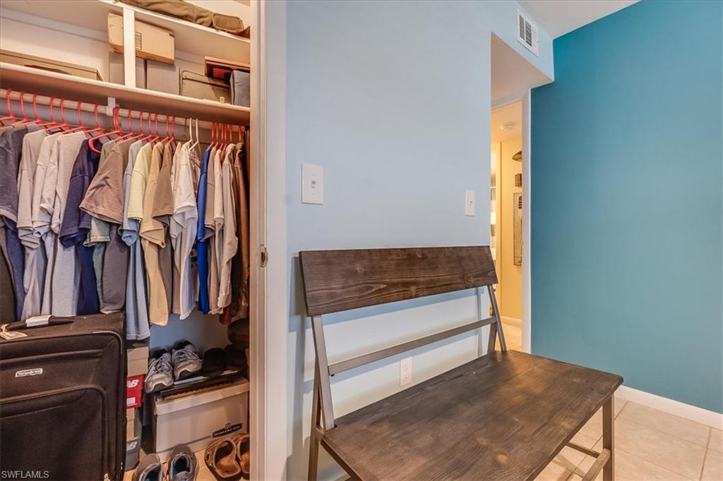 4290 Gulfstream Drive, Unit 4 Naples, FL 34112 - Photo 17 of 20 a view of walk in closet with clothes and shoes