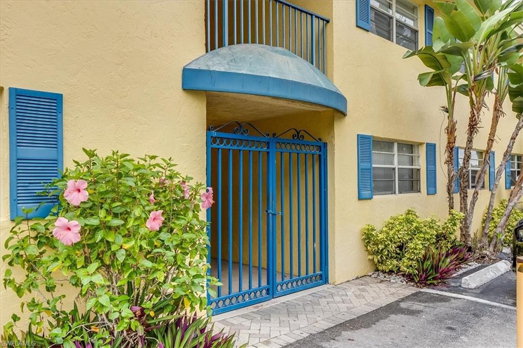 4290 Gulfstream Drive, Unit 4 Naples, FL 34112 - Photo 18 of 20 a view of a house with a flower garden