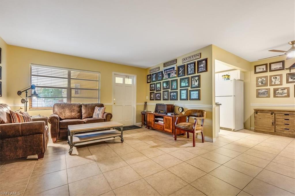 4290 Gulfstream Drive, Unit 4 Naples, FL 34112 - Photo 4 of 20 a living room with furniture and a floor to ceiling window