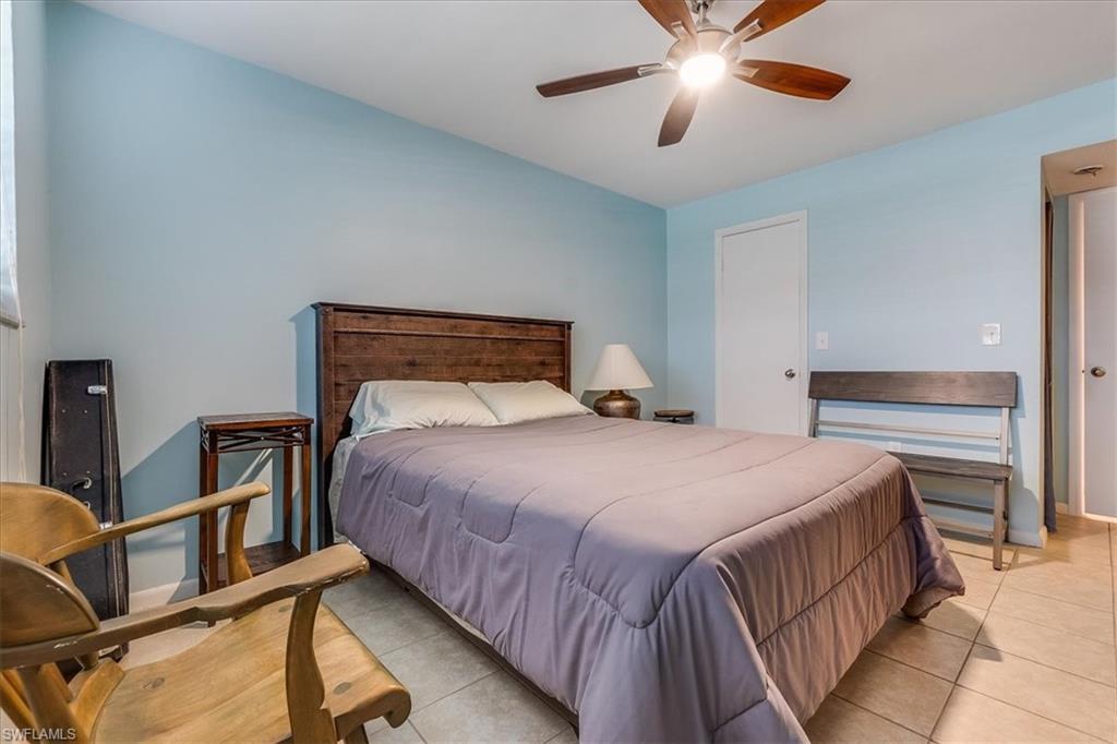 4290 Gulfstream Drive, Unit 4 Naples, FL 34112 - Photo 7 of 20 a bedroom with a bed and window