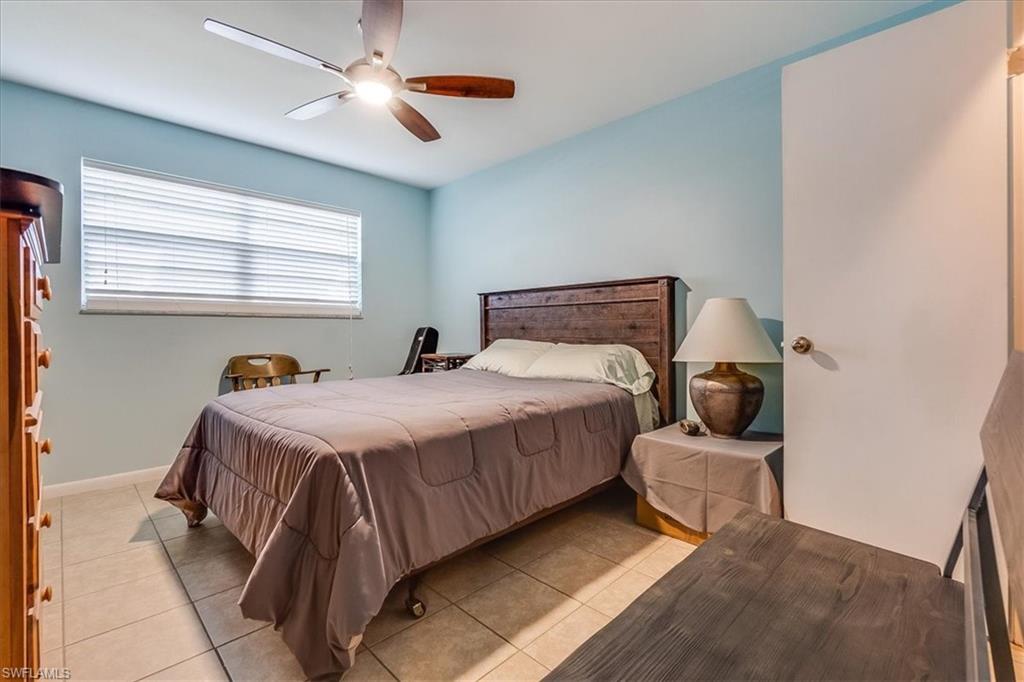 4290 Gulfstream Drive, Unit 4 Naples, FL 34112 - Photo 8 of 20 a bedroom with a bed and window