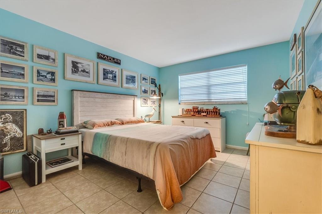 4290 Gulfstream Drive, Unit 4 Naples, FL 34112 - Photo 10 of 20 a bedroom with a bed and a dresser
