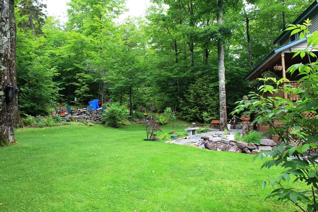 558 Rockwood Road Greenville Junction, ME 04442 - Photo 5 of 31 Side lawn with fire pit area