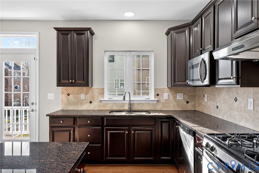 1903 Old Brick Road Glen Allen, VA 23060 - Photo 14 of 39 a kitchen with stainless steel appliances granite countertop a sink stove and cabinets