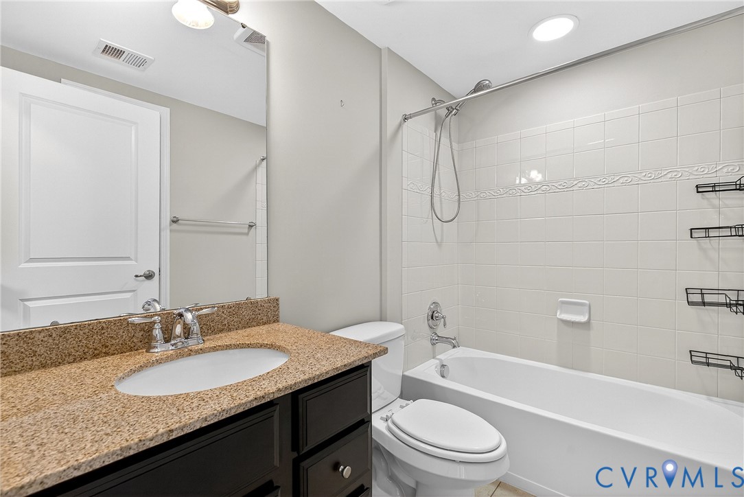 1903 Old Brick Road Glen Allen, VA 23060 - Photo 27 of 39 a bathroom with a granite countertop sink toilet a shower and a mirror