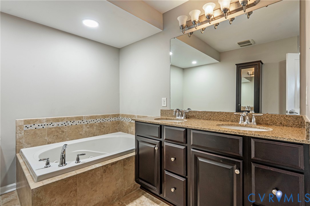 1903 Old Brick Road Glen Allen, VA 23060 - Photo 37 of 39 a bathroom with a tub a double vanity sink and mirror