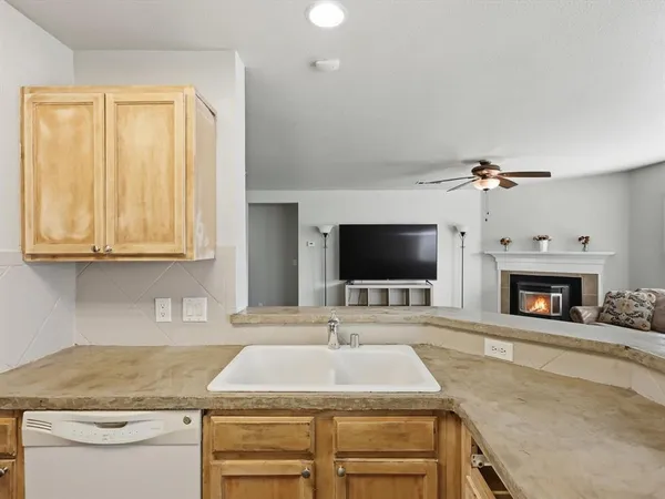 a kitchen with a sink and a fireplace