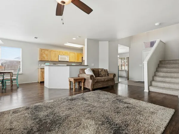 a living room with furniture and a kitchen view