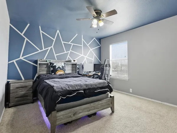 a bed sitting in a bedroom next to a window