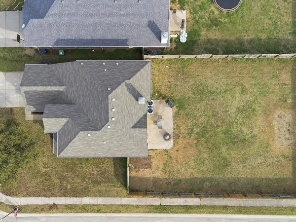 an aerial view of a house with a yard