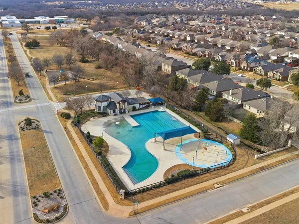 an aerial view of a residential houses with outdoor space