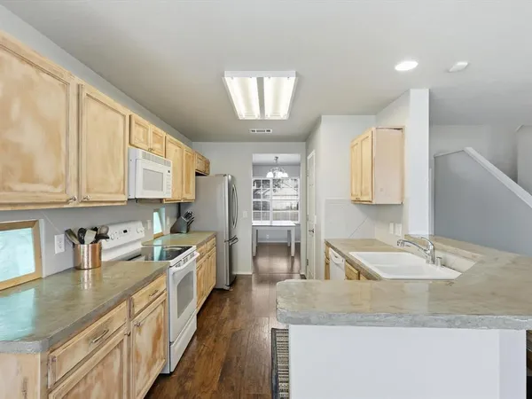 a kitchen with stainless steel appliances granite countertop a sink stove and cabinets
